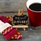 Concept january message on blackboard with a Cup of coffee and mittens